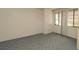 Bedroom with neutral walls, carpet, and two windows at 7501 Woodbox Row, Hudson, FL 34667