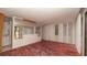 Bedroom featuring mirrored wall paneling, white curtains, and a closet cabinet at 7501 Woodbox Row, Hudson, FL 34667