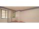 A bedroom with neutral walls, carpet and two windows at 7501 Woodbox Row, Hudson, FL 34667