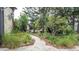 A beautifully landscaped front yard with a walkway enhances the home's curb appeal at 7501 Woodbox Row, Hudson, FL 34667