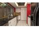 A well-lit kitchen featuring stainless steel appliances, black countertops, and ample cabinet space at 7501 Woodbox Row, Hudson, FL 34667