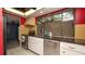 A well-lit kitchen featuring stainless steel appliances, black countertops, and ample cabinet space at 7501 Woodbox Row, Hudson, FL 34667