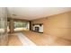 A spacious living room with a fireplace and sliding glass doors leading to the lanai at 7501 Woodbox Row, Hudson, FL 34667