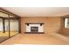 A spacious living room with a fireplace and sliding glass doors leading to the lanai at 7501 Woodbox Row, Hudson, FL 34667