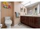 Well-lit bathroom with neutral tones, a spacious vanity, and a toilet, designed for comfort and functionality at 7512 Heather Walk Dr, Weeki Wachee, FL 34613