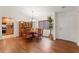 Dining room with hardwood floors, wooden table, chairs, and a built-in china cabinet, adjacent to the kitchen at 7512 Heather Walk Dr, Weeki Wachee, FL 34613