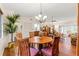 Dining room with hardwood floors, wooden table, chairs, and a built-in china cabinet, open to the living room at 7512 Heather Walk Dr, Weeki Wachee, FL 34613