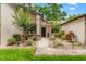 Charming single-story home with a well-manicured lawn, garden beds, and a brick pathway leading to the front entrance at 7512 Heather Walk Dr, Weeki Wachee, FL 34613