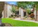 Charming single-story home with a well-manicured lawn, garden beds, and a brick pathway leading to the front entrance at 7512 Heather Walk Dr, Weeki Wachee, FL 34613