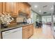 Well-lit kitchen featuring wooden cabinets, granite countertops, and modern appliances, creating a warm and inviting space at 7512 Heather Walk Dr, Weeki Wachee, FL 34613