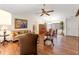 Cozy living room with hardwood floors, vaulted ceilings, neutral paint, classic furnishings, and open to the dining room at 7512 Heather Walk Dr, Weeki Wachee, FL 34613