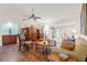 Comfortable living room with hardwood floors, neutral paint, large windows, and open to the dining room at 7512 Heather Walk Dr, Weeki Wachee, FL 34613