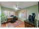 Home office with a green accent wall, desk, and natural light, perfect for productivity and focus at 7512 Heather Walk Dr, Weeki Wachee, FL 34613