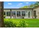 Charming patio area with seating, well-maintained landscaping, and a view of the backyard at 7512 Heather Walk Dr, Weeki Wachee, FL 34613