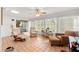 Cozy sunroom with tiled flooring, ceiling fan, and multiple windows providing plenty of natural light at 7512 Heather Walk Dr, Weeki Wachee, FL 34613