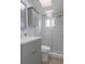 Bathroom features a glass shower, modern vanity, marble tiling, and neutral gray color scheme at 7520 Mako Dr, Hudson, FL 34667