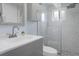 Bathroom features a glass shower, modern vanity, marble tiling, and neutral gray color scheme at 7520 Mako Dr, Hudson, FL 34667