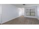 Bright bedroom with wood-look tile flooring, a large window, and neutral walls at 7520 Mako Dr, Hudson, FL 34667
