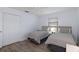Bright bedroom with two twin beds, closet and neutral colors for a calming atmosphere at 7520 Mako Dr, Hudson, FL 34667