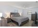 Spacious bedroom with two windows, ceiling fan and king bed with coordinated nightstands at 7520 Mako Dr, Hudson, FL 34667