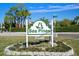 A view of the Sea Pines community sign, with beautiful trees surrounding it at 7520 Mako Dr, Hudson, FL 34667