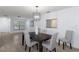 Well-lit dining area with wood-look tile, featuring a modern light fixture at 7520 Mako Dr, Hudson, FL 34667