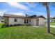 Inviting single-story home featuring stone accents and a well-manicured lawn with a palm tree at 7520 Mako Dr, Hudson, FL 34667