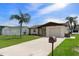 Well-maintained single-story home with a tidy front yard and a classic mailbox along the driveway at 7520 Mako Dr, Hudson, FL 34667