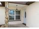 Inviting front entrance featuring a stone pillar and a white door, creating a warm welcome at 7520 Mako Dr, Hudson, FL 34667