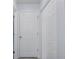 Hallway with white doors and neutral paint, offering a clean and simple aesthetic at 7520 Mako Dr, Hudson, FL 34667