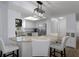 Bright kitchen with stainless steel appliances, granite countertops, and an island with seating at 7520 Mako Dr, Hudson, FL 34667