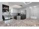 Modern kitchen featuring granite countertops, stainless steel appliances, and white cabinetry at 7520 Mako Dr, Hudson, FL 34667
