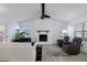 Comfortable living room features a brick fireplace, ceiling fan, and tile flooring at 7520 Mako Dr, Hudson, FL 34667