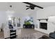Spacious living room with a brick fireplace, wood-look flooring, and sliding door access to the patio at 7520 Mako Dr, Hudson, FL 34667