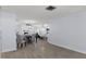 Open-concept living space with wood-look tile, seamlessly connecting dining, kitchen, and living areas at 7520 Mako Dr, Hudson, FL 34667