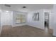 Versatile living space with wood-look tile, offering flexibility for various furniture arrangements and decor at 7520 Mako Dr, Hudson, FL 34667
