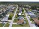 An aerial view of the neighborhood shows homes along a canal with mature trees and sidewalks at 7520 Mako Dr, Hudson, FL 34667