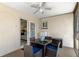 Cozy screened patio featuring a ceiling fan, table with seating for four, and access to the home's interior at 7520 Mako Dr, Hudson, FL 34667