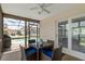 Screened patio with table and seating offers views of the pool and backyard, perfect for outdoor dining at 7520 Mako Dr, Hudson, FL 34667