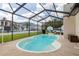 View of the pool surrounded by a screened enclosure, offering a private and enjoyable backyard space at 7520 Mako Dr, Hudson, FL 34667