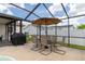 Inviting pool area featuring a dining set, barbecue, and white privacy fence, perfect for relaxation at 7520 Mako Dr, Hudson, FL 34667