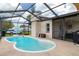 Relax by the pool with view of the backyard, equipped with basketball hoop and shaded dining area at 7520 Mako Dr, Hudson, FL 34667