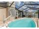 Enjoy the enclosed pool with seating area, grill, and a basketball hoop for fun outdoor recreation at 7520 Mako Dr, Hudson, FL 34667