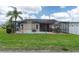 This home has a screened-in pool, outdoor dining set, grill, and nicely kept lawn at 7520 Mako Dr, Hudson, FL 34667