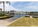 This is a view of the community canal with docks. Palm trees and blue skies complete the scenery at 7520 Mako Dr, Hudson, FL 34667