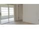 Bedroom with sliding glass door, neutral carpet, and light walls, offering a bright and versatile space at 7600 St. Andrews Blvd # 7600, Weeki Wachee, FL 34613