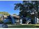 Blue condo building with white staircase and a large tree in the front yard with lush green grass at 7600 St. Andrews Blvd # 7600, Weeki Wachee, FL 34613