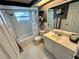 Bathroom with tub/shower combination, white vanity and gray accents at 7719 Gaston Dr, Port Richey, FL 34668