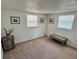 Cozy bedroom with neutral walls, carpet flooring, and natural light from two windows at 7719 Gaston Dr, Port Richey, FL 34668