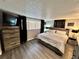 Bedroom with wood-look flooring, closet, dresser and window at 7719 Gaston Dr, Port Richey, FL 34668